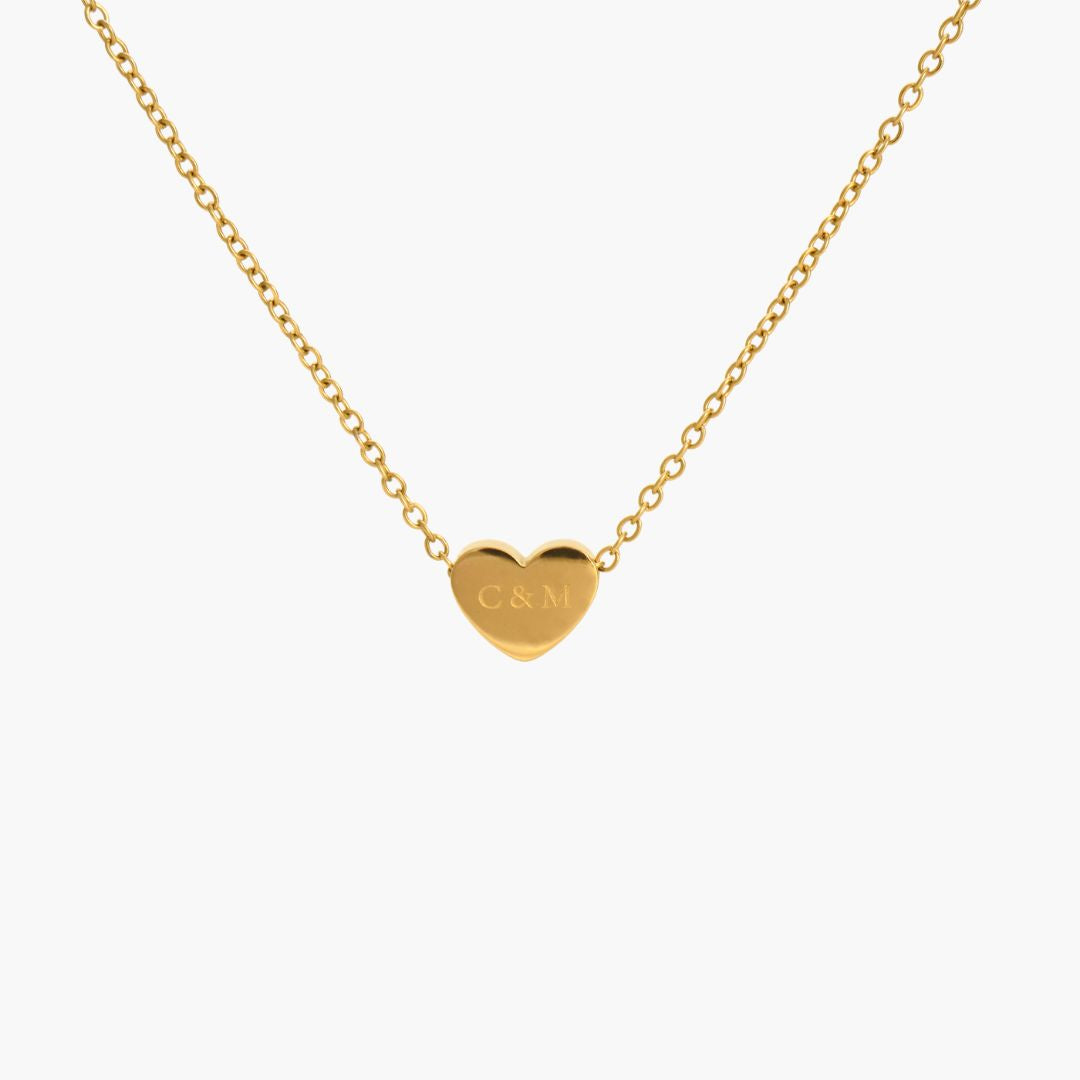 JUNE ELLE gold custom heart necklace engraved with C&M front view on white background