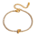 JUNE ELLE gold initial tennis bracelet with letter F arranged in a perfect circle on white background front view