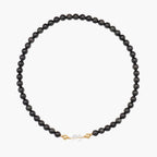 JUNE ELLE MagMix Black Obsidian Bead Necklace and a Clear Quartz Jelly Bean Centerpiece connected via a central gold magnetic clasp on a pure white background, showcasing modular combinations.