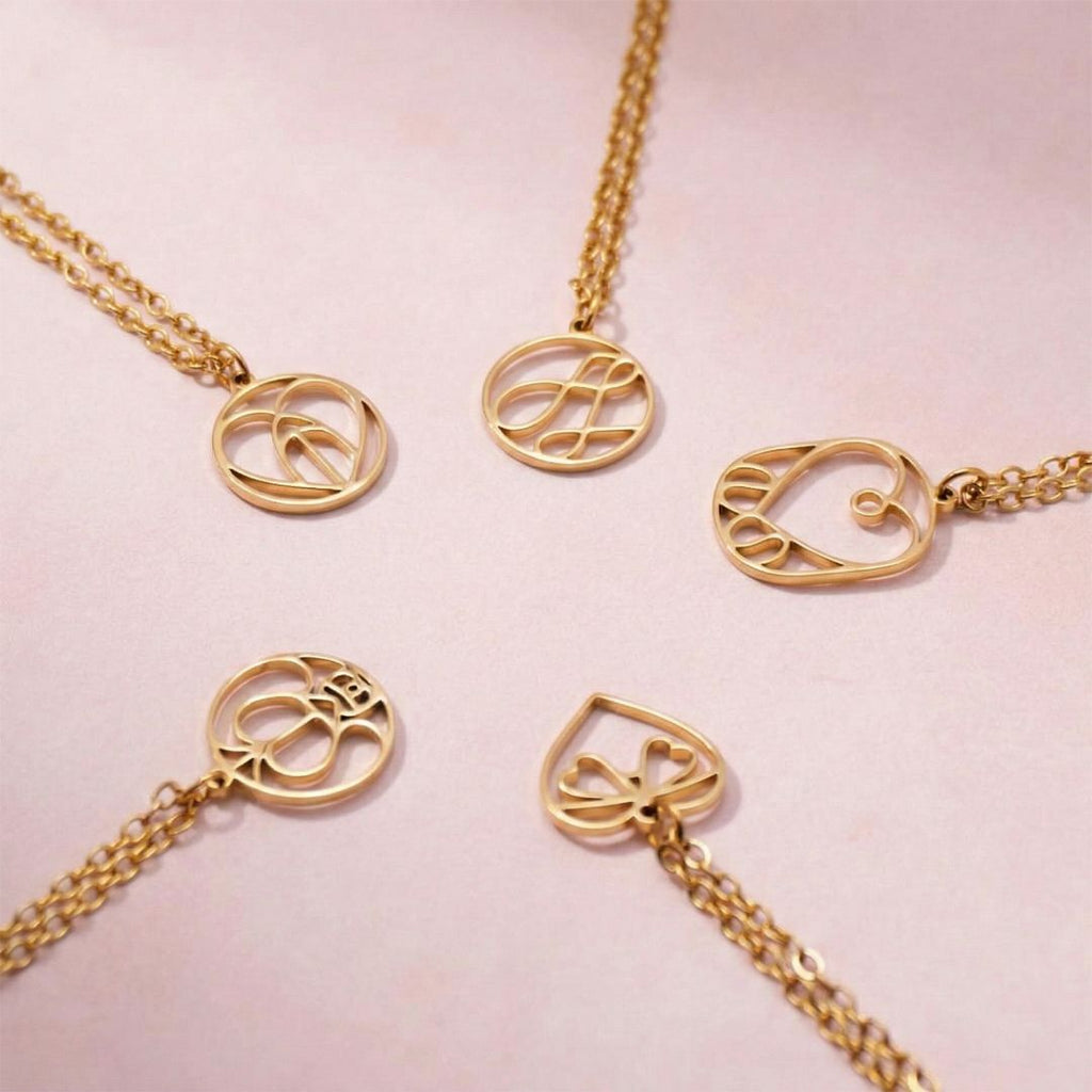 JUNE ELLE gold monogram necklace with letter-formed designs in round, oval and heart shapes arranged in a circle