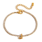 JUNE ELLE gold initial tennis bracelet with letter J arranged in a perfect circle on white background front view