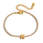 JUNE ELLE gold initial tennis bracelet with letter K arranged in a perfect circle on white background front view