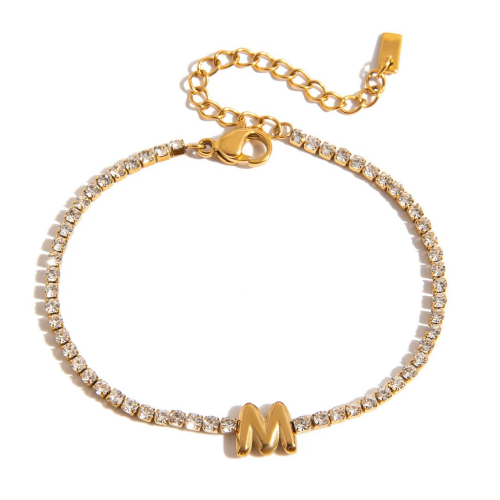 JUNE ELLE gold initial tennis bracelet with letter M arranged in a perfect circle on white background front view