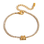 JUNE ELLE gold initial tennis bracelet with letter M arranged in a perfect circle on white background front view