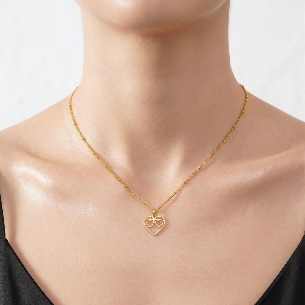 JUNE ELLE gold custom monogram necklace with JADE in heart-shaped pendant worn on model