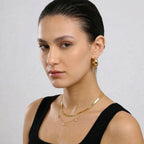 JUNE ELLE gold custom herringbone name necklace worn in layered styling on model side angle