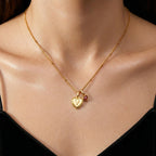 JUNE ELLE gold heart initial charm featuring letter V paired with a heart birthstone charm on sphere chain necklace worn on model front view, available in A to Z initials