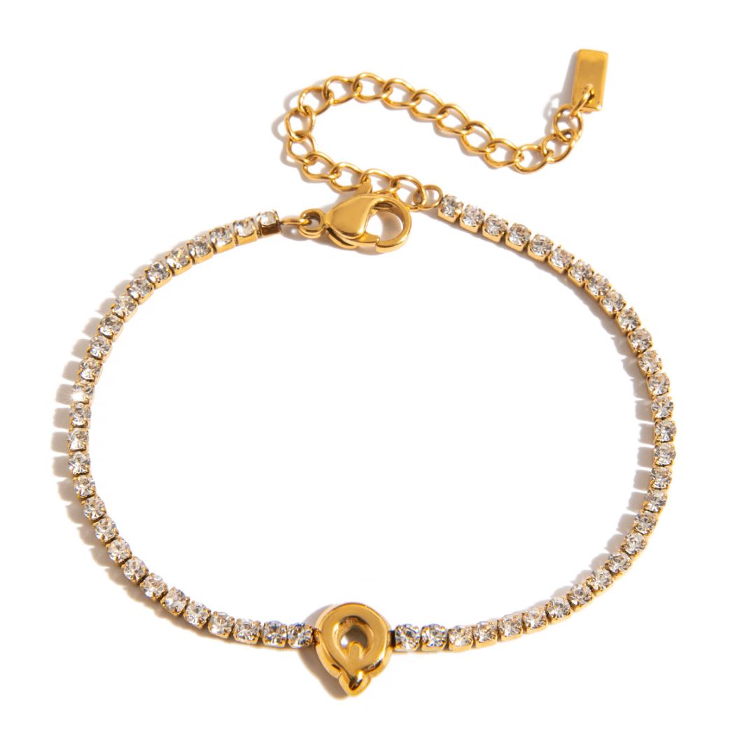 JUNE ELLE gold initial tennis bracelet with letter Q arranged in a perfect circle on white background front view