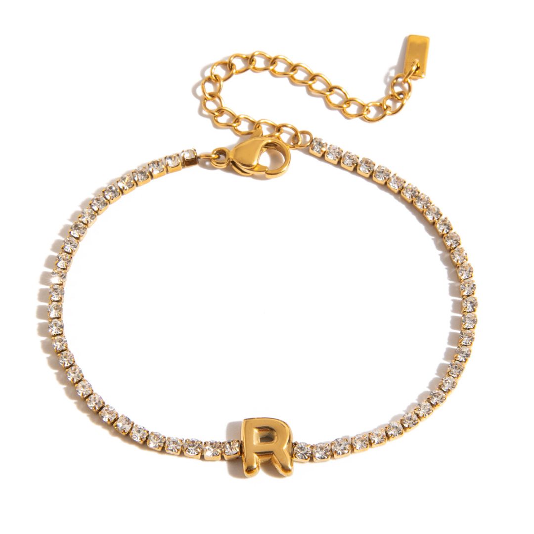 JUNE ELLE gold initial tennis bracelet with letter R arranged in a perfect circle on white background front view