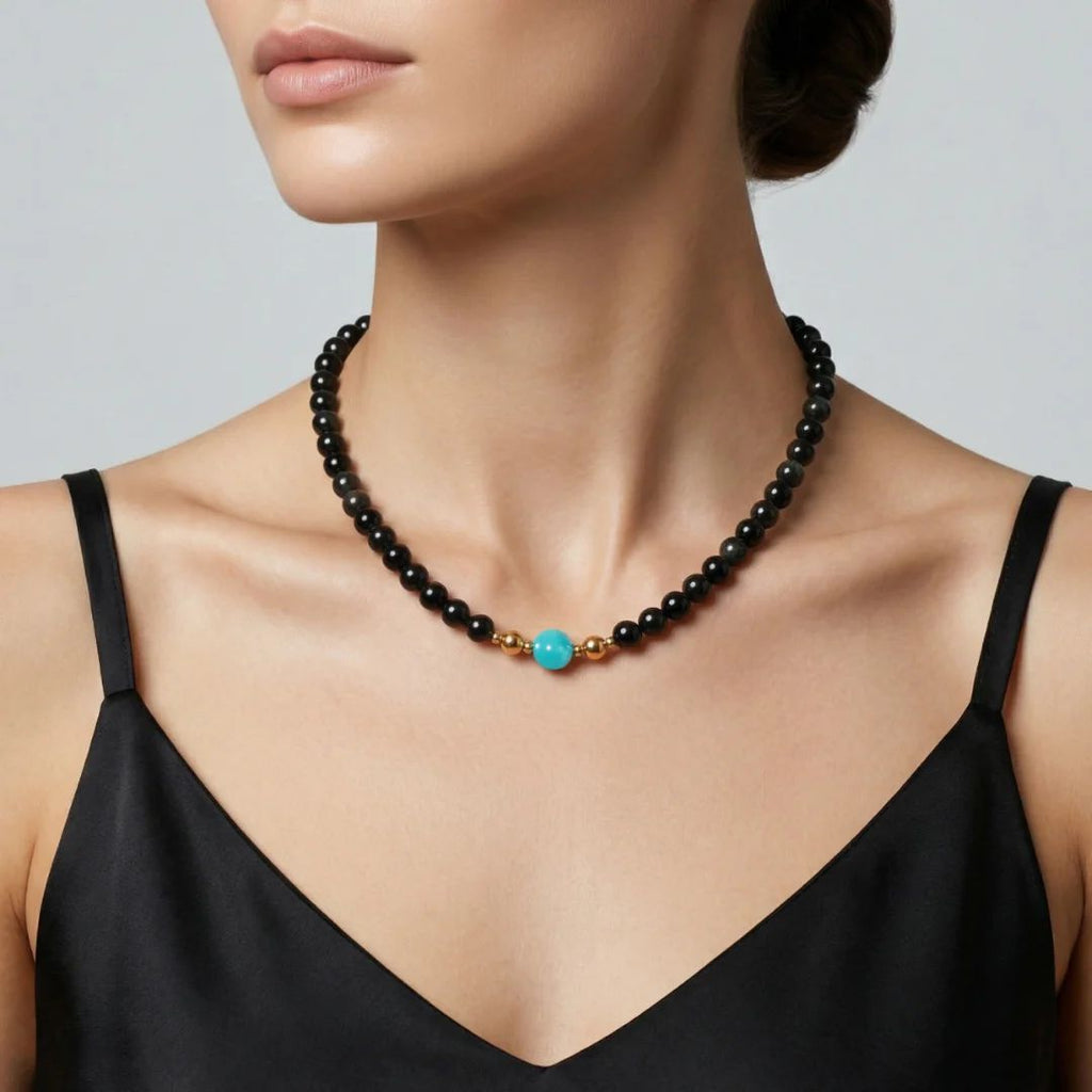 Close-up on model's collarbone featuring the JUNE ELLE MagMix modular necklace, pairing a black Obsidian beaded choker with an Amazonite focal piece, seamlessly joined by gold magnetic clasps.