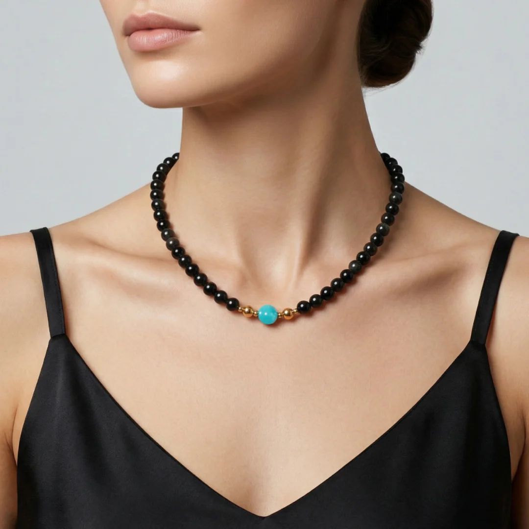 Close-up on model's collarbone featuring the JUNE ELLE MagMix modular necklace, pairing a black Obsidian beaded choker with an Amazonite focal piece, seamlessly joined by gold magnetic clasps.