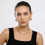 JUNE ELLE gold engraved name necklace styled in a minimal layered look on model front view