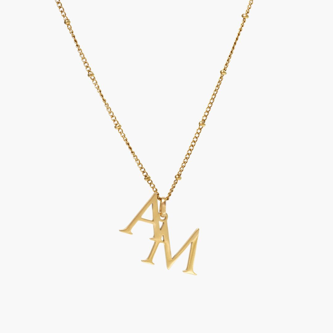 JUNE ELLE gold custom dual initial necklace featuring two initials front view on white background