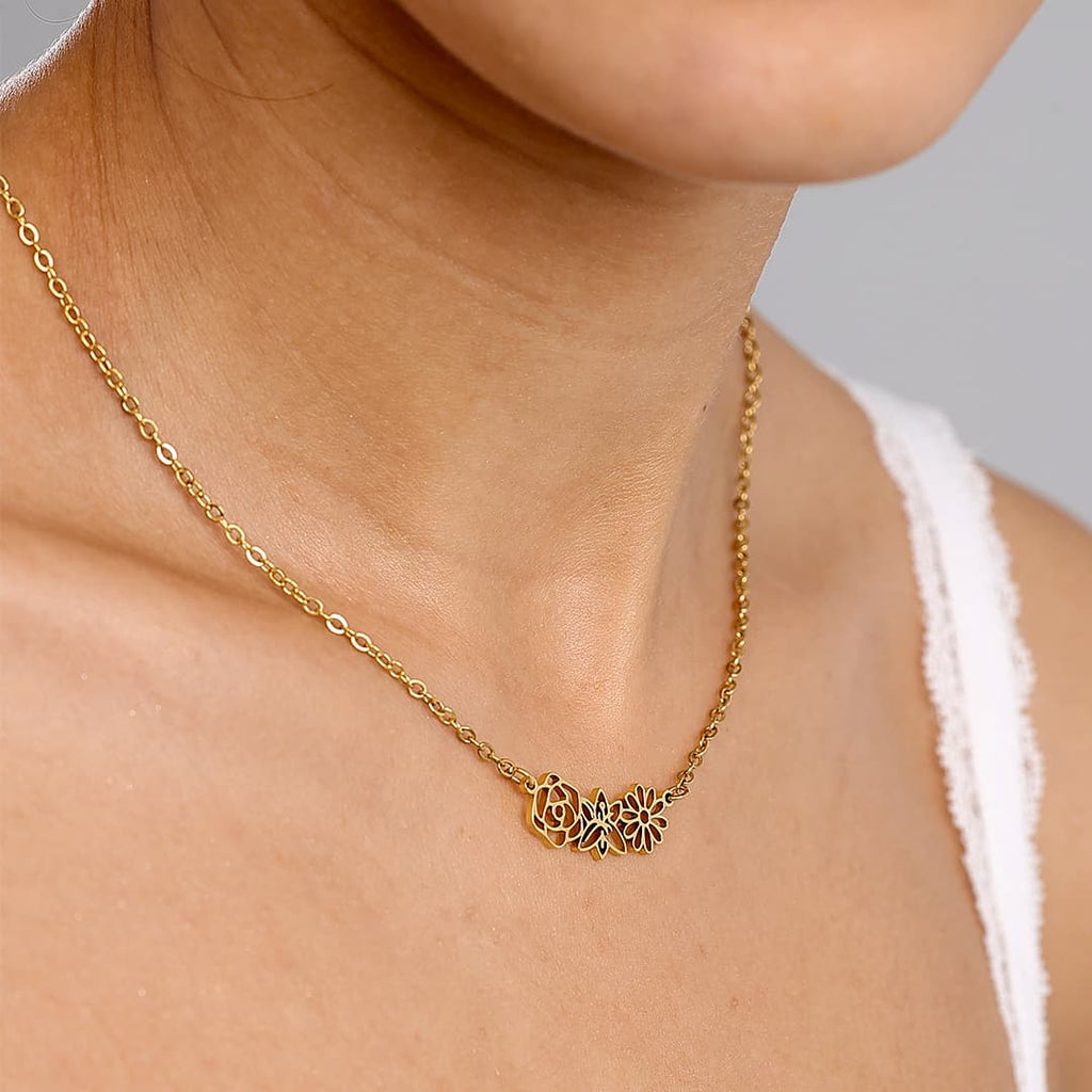 JUNE ELLE gold multiple birth flowers necklace with April Daisy, May Lily and June Rose integrated into chain worn on model close side angle
