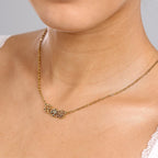 JUNE ELLE gold multiple birth flowers necklace with April Daisy, May Lily and June Rose integrated into chain worn on model minimal styling front view