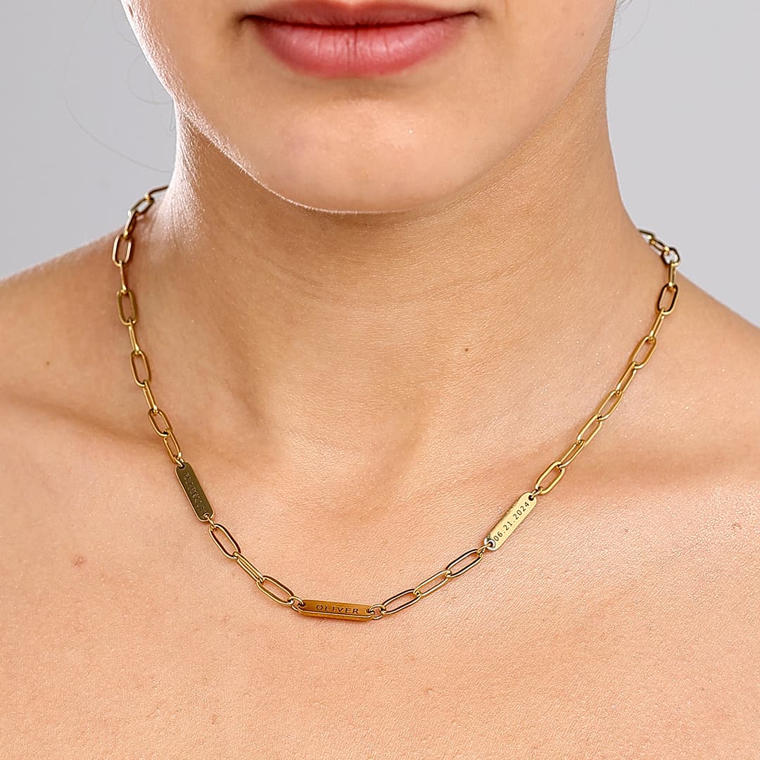 JUNE ELLE gold engraved tag name necklace on paperclip chain with Isabella, Oliver and 06.21.2024 worn on model close front view