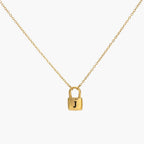 JUNE ELLE gold lock initial necklace with black letter J on lock pendant front view on white background, customizable A to Z initials