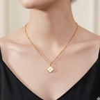 JUNE ELLE gold mother-of-pearl clover initial charm letter A on sphere chain necklace worn on model front view, customizable A to Z