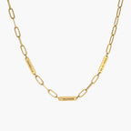 JUNE ELLE gold custom engraved tag necklace featuring Isabella, Oliver and 06.21.2024 on paperclip chain front view on white background