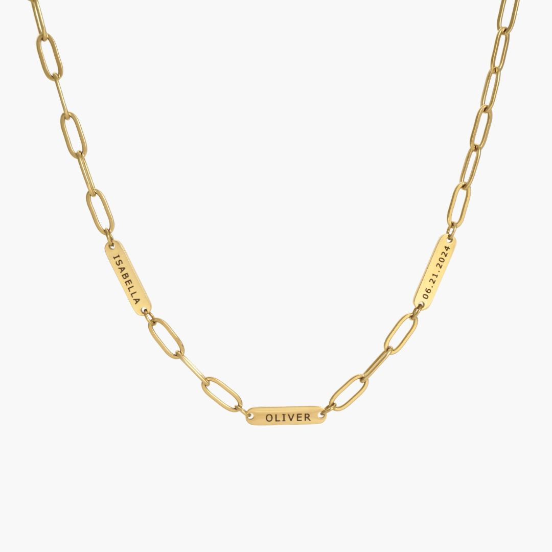 JUNE ELLE gold custom engraved tag necklace featuring Isabella, Oliver and 06.21.2024 on paperclip chain front view on white background