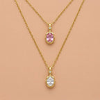 JUNE ELLE 14K gold plated stainless steel birthstone pendant necklaces, 2 different months displayed on light orange background, front view