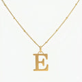 JUNE ELLE 18K gold plated stainless steel personalized E initial pendant necklace, custom letter jewelry shown in clear front view