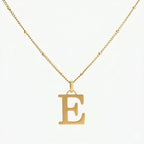 JUNE ELLE 18K gold plated stainless steel personalized E initial pendant necklace, custom letter jewelry shown in clear front view