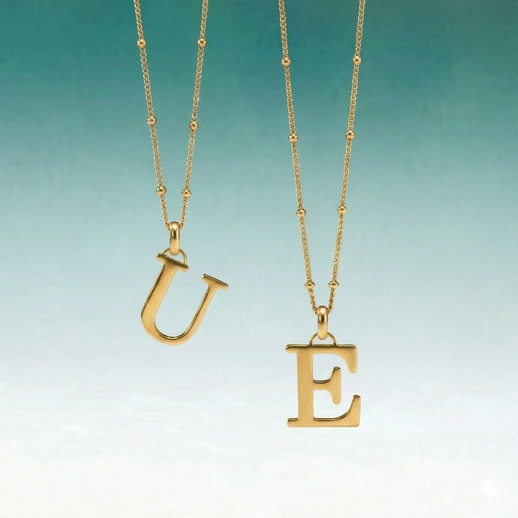 JUNE ELLE personalized 18K gold plated stainless steel initial pendant necklace with E and U letters, styled hanging scene