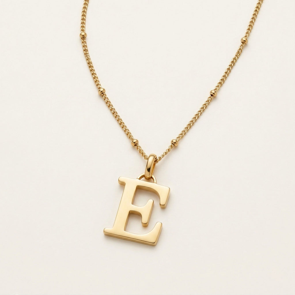 JUNE ELLE 18K gold plated stainless steel personalized initial pendant necklace, custom letter jewelry shown in side angle top-down view
