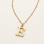 JUNE ELLE 18K gold plated stainless steel personalized initial pendant necklace, custom letter jewelry shown in side angle top-down view