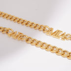 Close-up of a JUNE ELLE 18K gold plated stainless steel curb chain necklace with integrated custom letters.