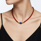 Model wearing the JUNE ELLE MagMix interchangeable necklace, combining a red carnelian bead base chain with a lapis lazuli barrel centerpiece connected by gold magnetic clasps.
