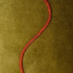 JUNE ELLE Natural Carnelian MagMix Bead Necklace close-up detail on green velvet background