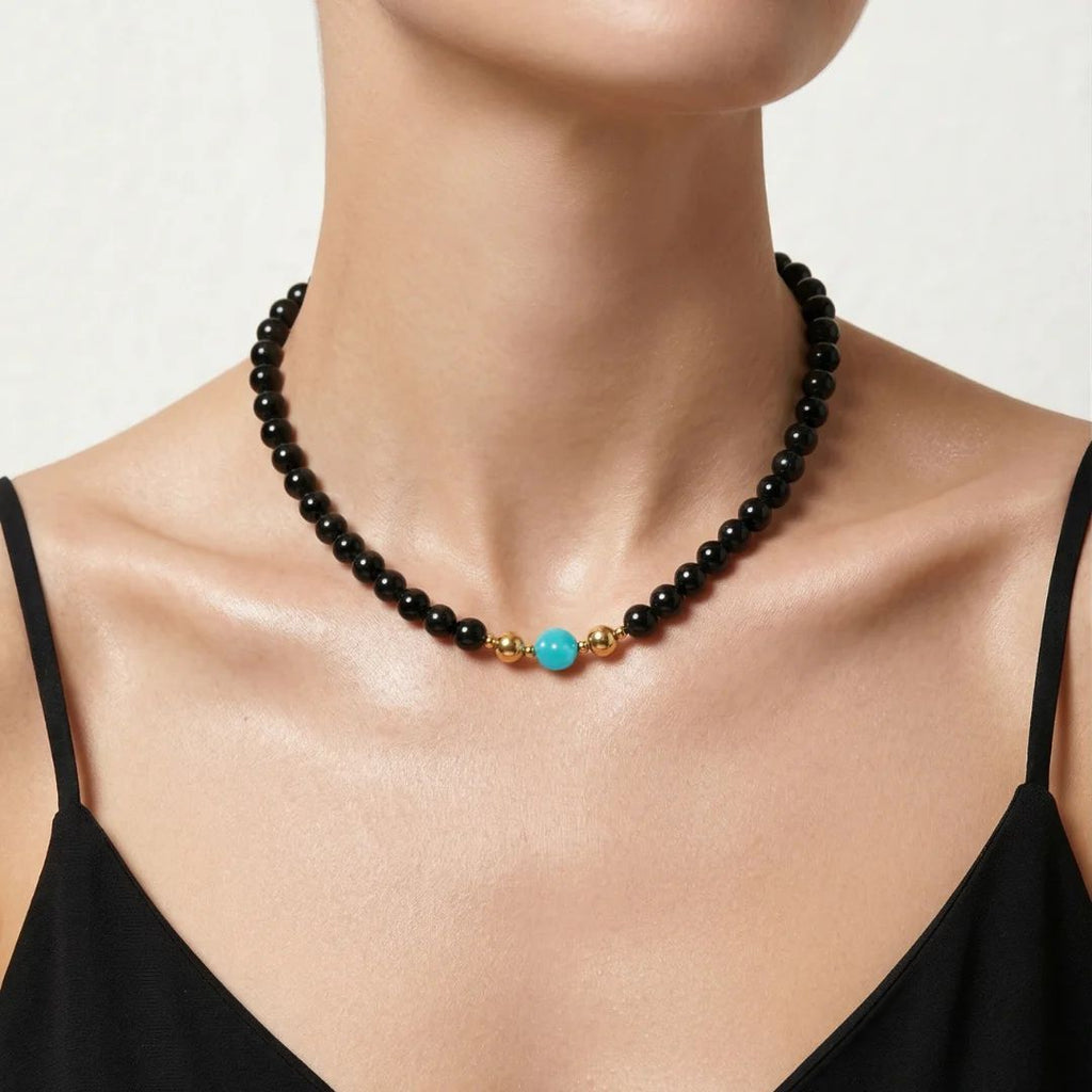 Model wearing the JUNE ELLE MagMix interchangeable necklace, combining an Obsidian bead chain with an Amazonite centerpiece connected by gold magnetic clasps.