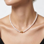 Model wearing the JUNE ELLE MagMix Rose Quartz Bead Chain Necklace with a front-facing gold magnetic clasp. 