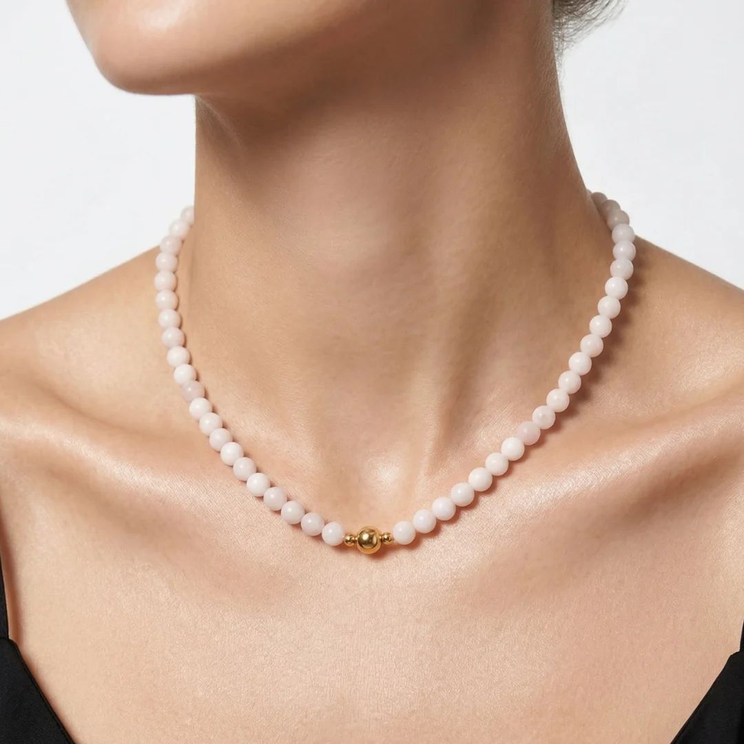 Model wearing the JUNE ELLE MagMix Rose Quartz Bead Chain Necklace with a front-facing gold magnetic clasp. 