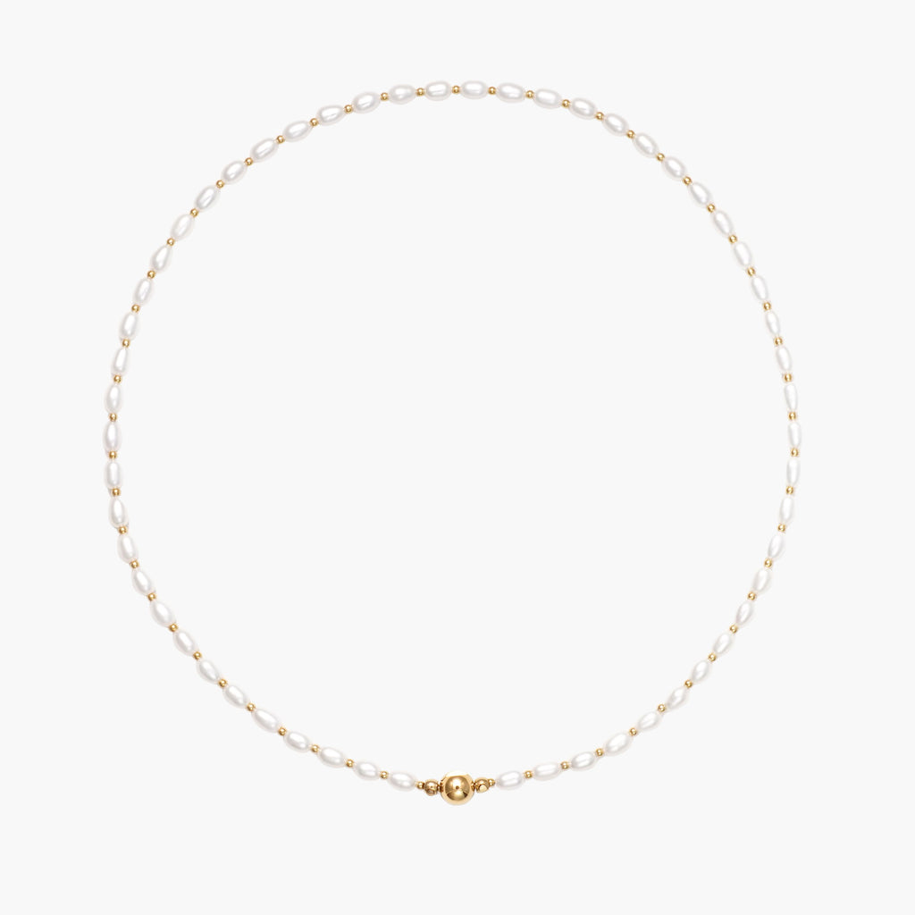 JUNE ELLE MagMix Seed Pearl and Gold Spacer Bead Necklace with a central gold magnetic clasp on a pure white background, allowing for modular combinations with other MagMix pieces.