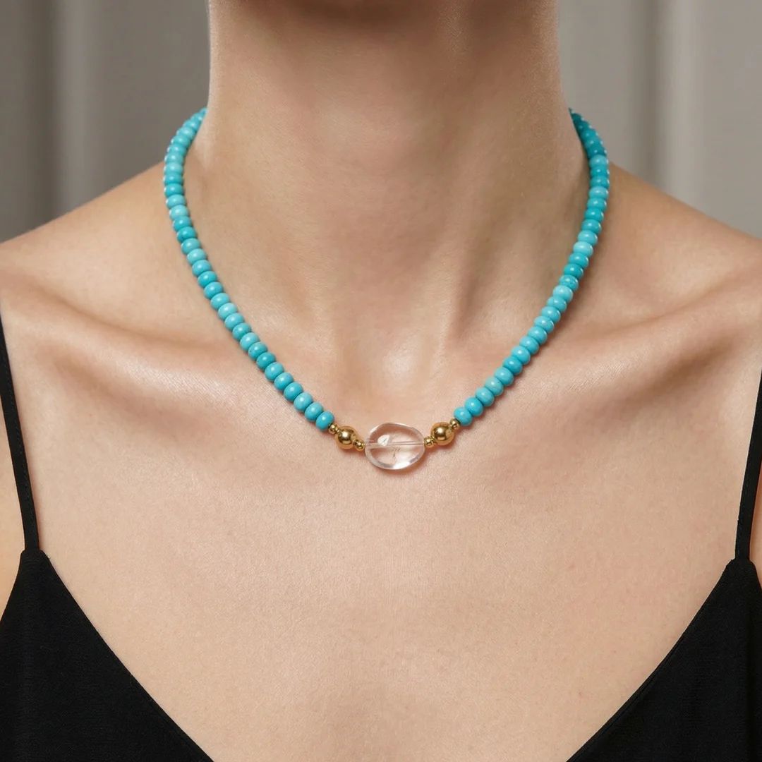 Model wearing the JUNE ELLE MagMix interchangeable necklace, combining a turquoise bead base chain with a Clear Quartz Jelly Bean centerpiece connected by gold magnetic clasps. 