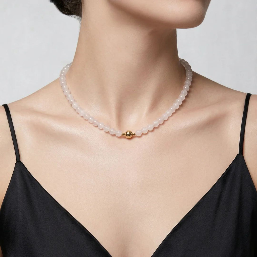 Model wearing the JUNE ELLE White Chalcedony Bead Chain Necklace with a front-facing gold magnetic clasp.