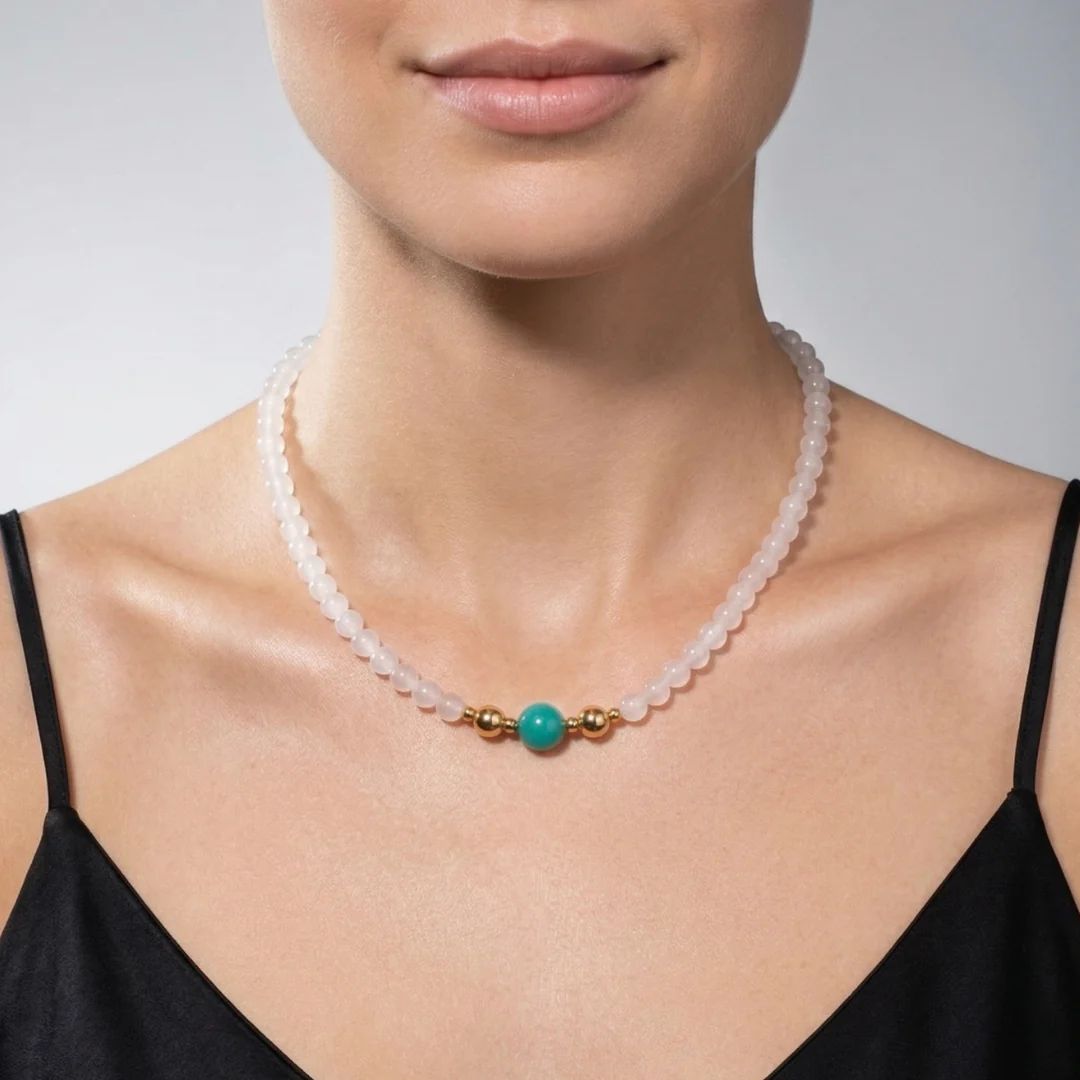 Model wearing the JUNE ELLE MagMix interchangeable necklace, combining a soft white chalcedony bead chain with an Amazonite centerpiece connected by gold magnetic clasps.