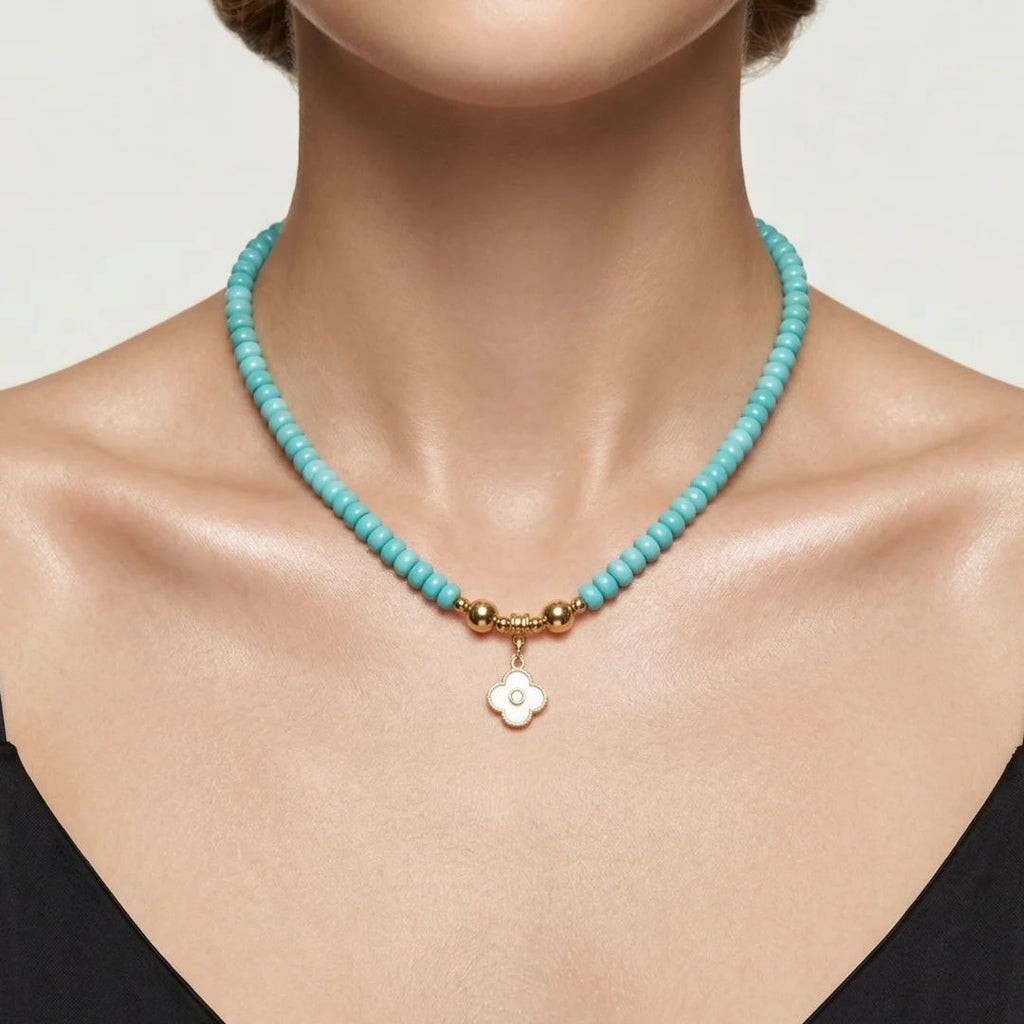 Model wearing the JUNE ELLE MagMix interchangeable necklace, combining a turquoise bead base chain with a custom gold mother-of-pearl clover initial charm centerpiece connected by gold magnetic clasps.