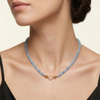 Model wearing the JUNE ELLE MagMix interchangeable necklace, combining a blue chalcedony bead base chain with a clear quartz centerpiece connected by gold magnetic clasps.