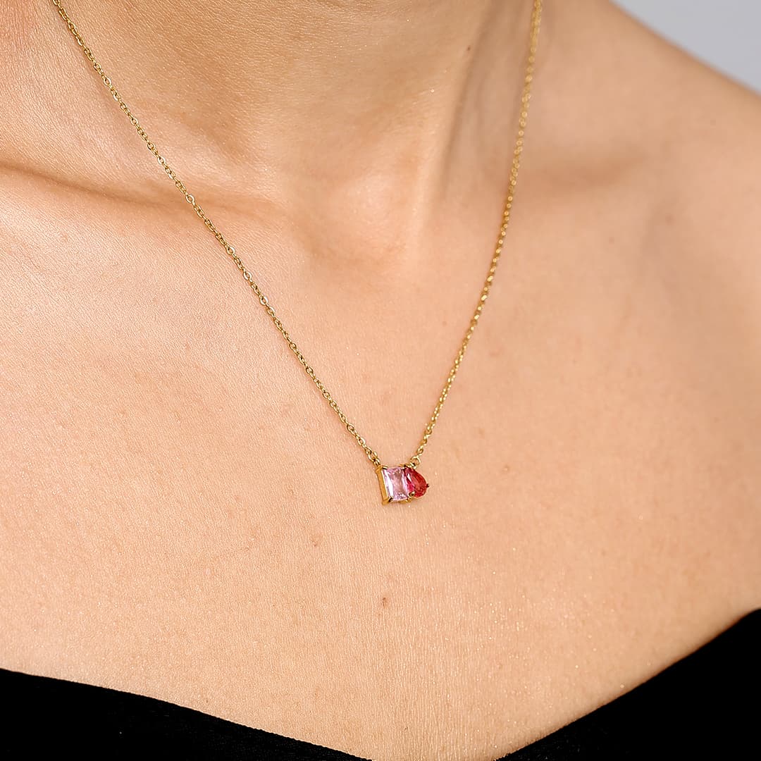 Side-angle view of a custom waterproof 18K gold PVD Toi et Moi necklace with pink birthstones on neck